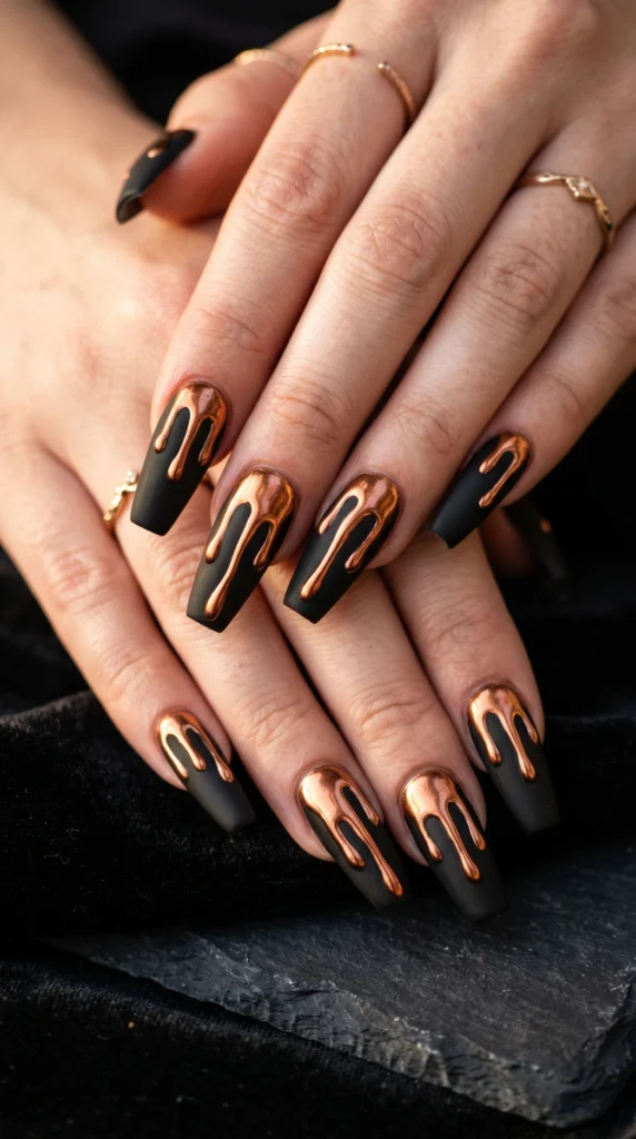 Coffin nails in matte black with copper chrome drip art from tips metallic warm molten look baddie