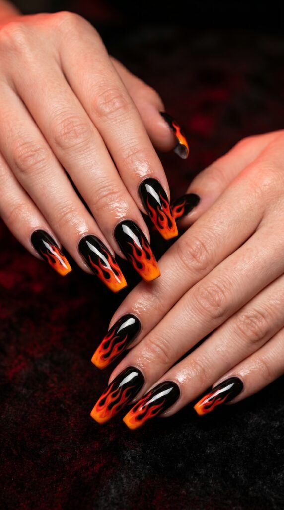 Coffin nails in black with hand-painted red orange flame tips rising from nail tip dramatic baddie art