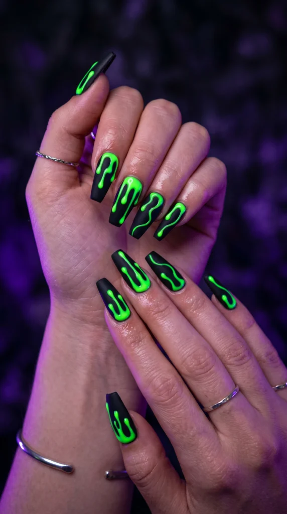 Coffin nails in matte black with vivid neon green gel drip art from tips toxic baddie editorial look