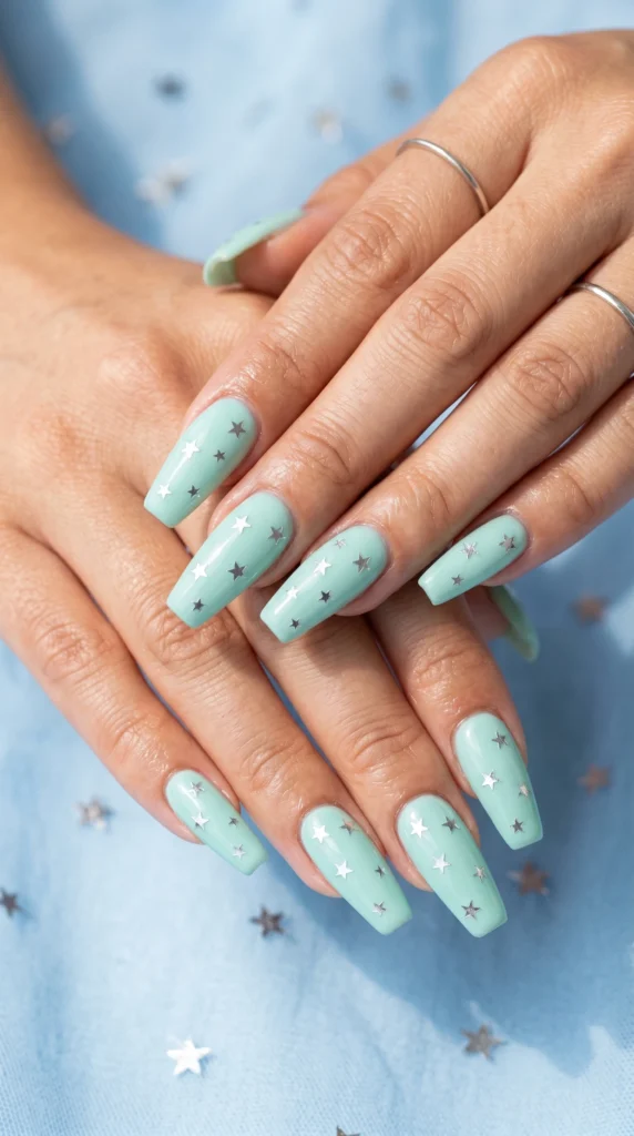 Coffin nails in soft mint green with scattered silver star foil constellation art glossy finish
