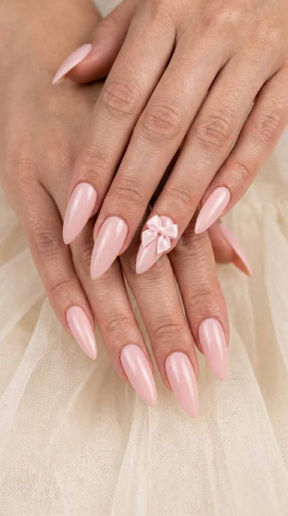 Stiletto nails in whisper ballet pink with satin ribbon bow charm accent for ballet core soft girl