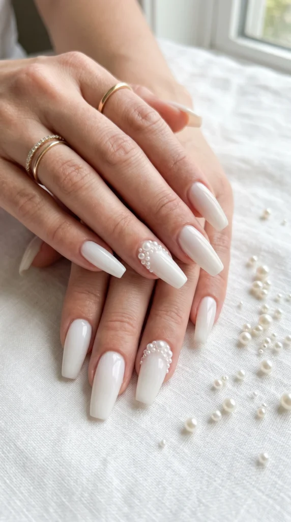 Coffin nails in opaque milky white with micro-pearl cluster accent nails for coquette soft girl look