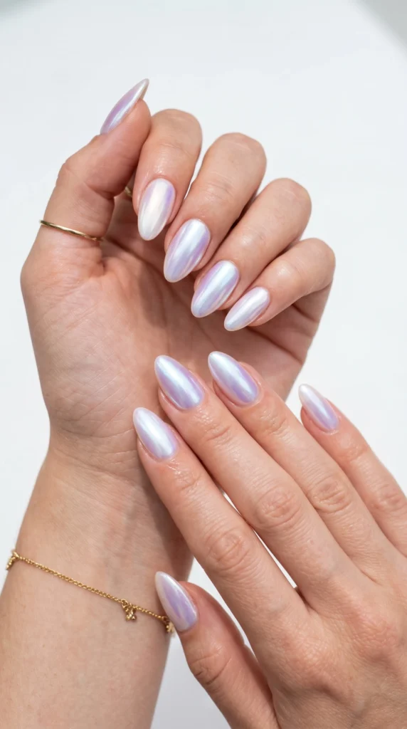 Almond nails in pearl white with aurora chrome powder finish shifting lilac and blue, moonstone iridescent style