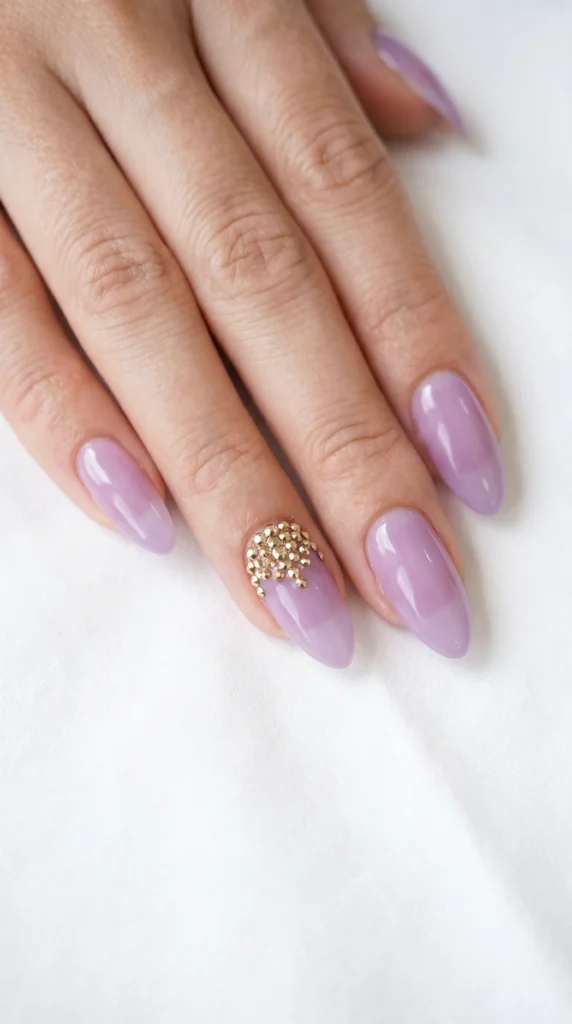 Almond nails in sheer lavender gel with gold rhinestone cluster accent nail, feminine bridal style