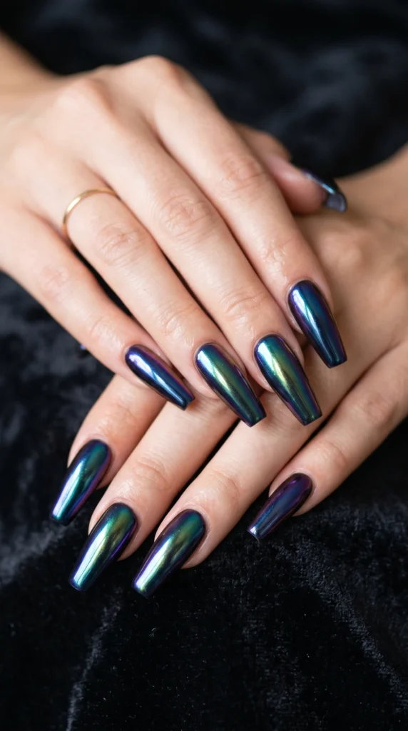 Long coffin nails with oil slick dark rainbow chrome shifting from blue to emerald to purple, edgy soft girl nail design 2026