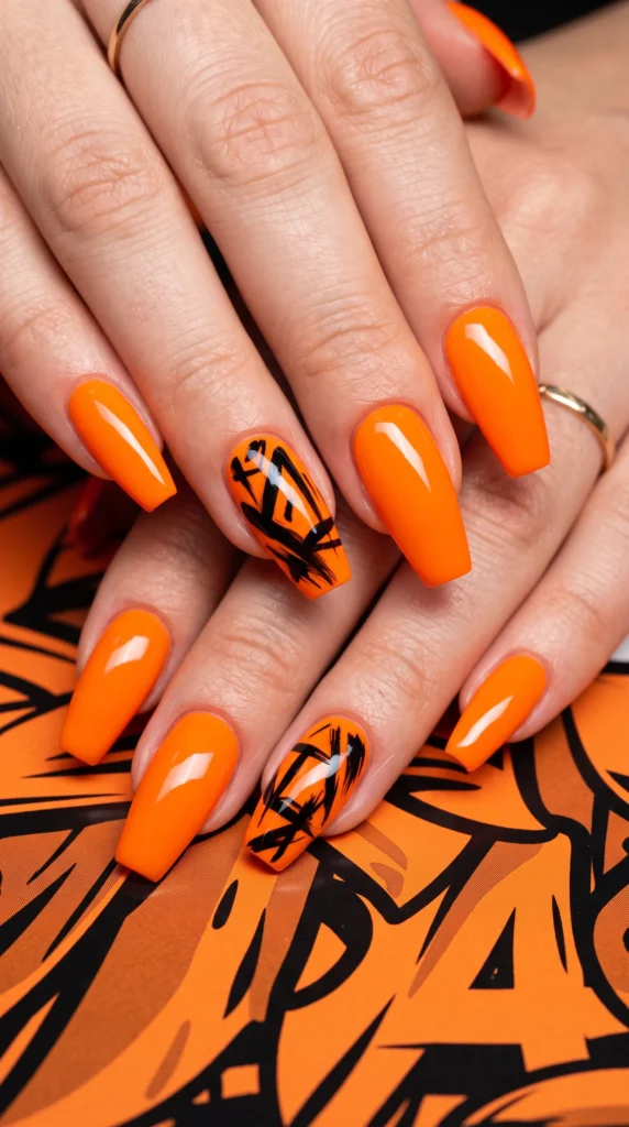 Coffin nails vivid orange with bold black abstract mark art accent nails editorial fearless mood