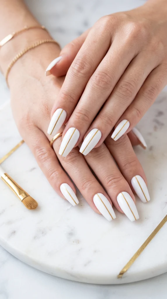 Coffin nails bright white with single thin gold line down center of each nail minimal perfect mood