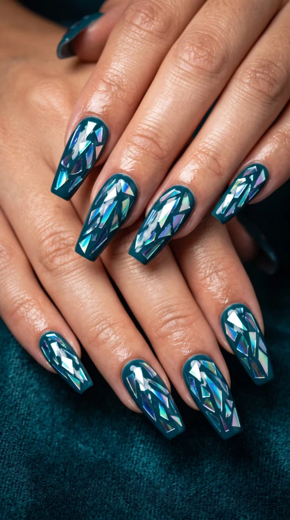 Coffin nails deep teal with iridescent mirror film shards cracked glass effect edgy avant-garde mood