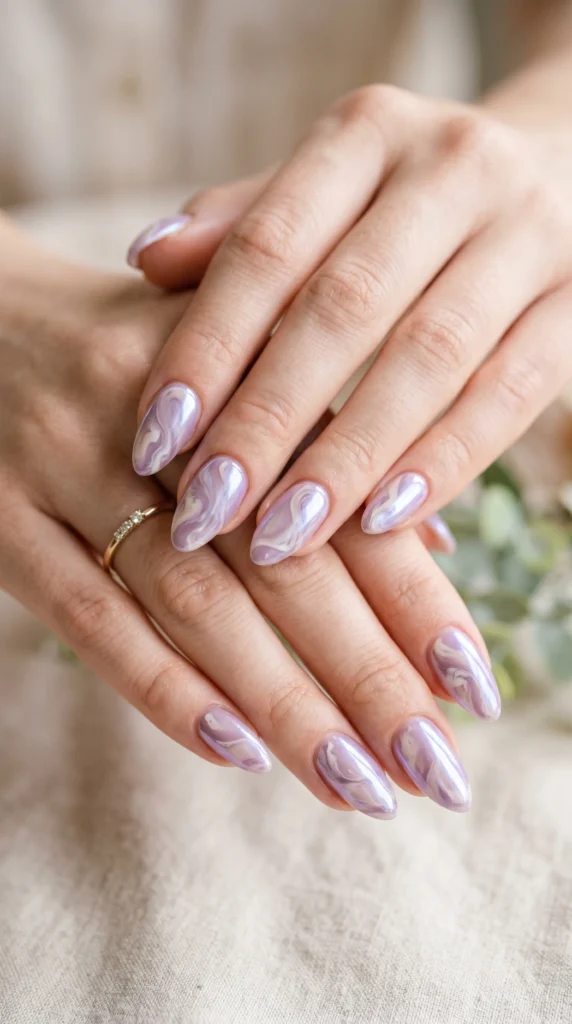 Almond nails with dusty lavender and cream swirl art under iridescent top coat — dreamy soft girl