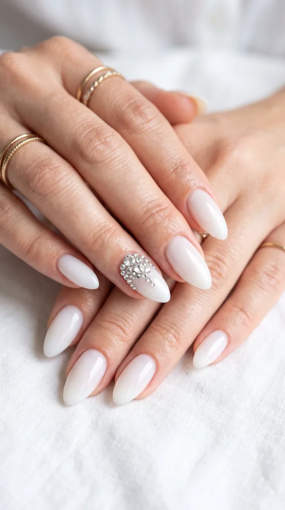 A woman with white nails and a ring on her finger.