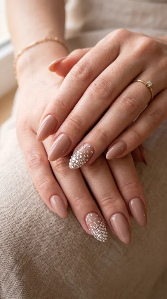 A woman's hand with a ring on her finger and a pink nail with a white design.