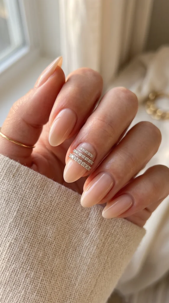 A woman with a manicured nail holding a ring.