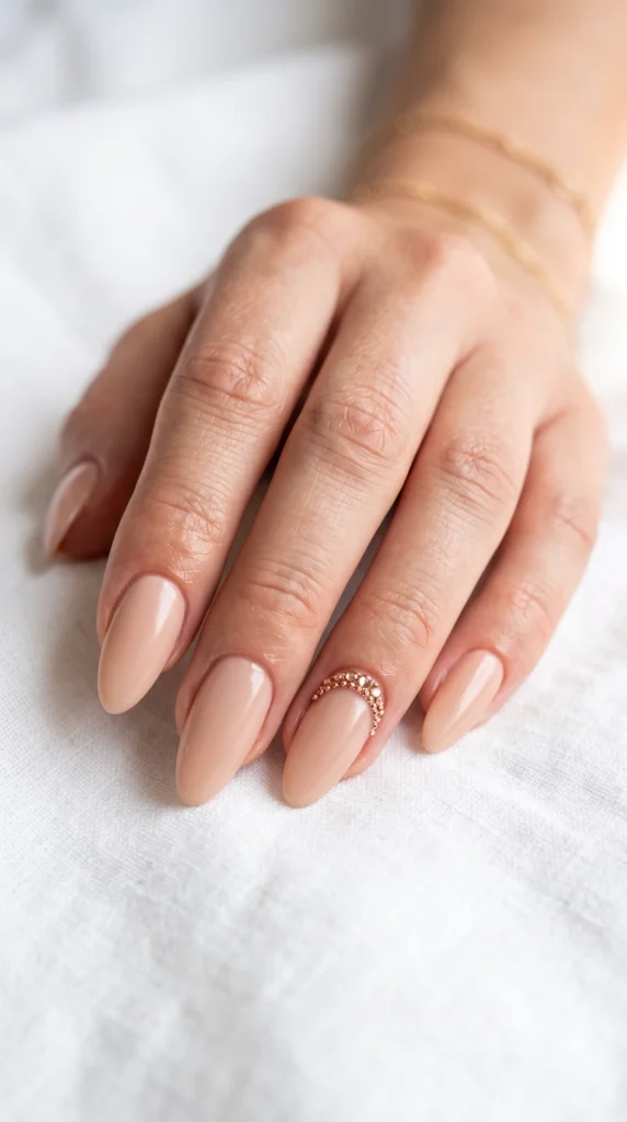 A woman's hand with a pink nail holding a ring.