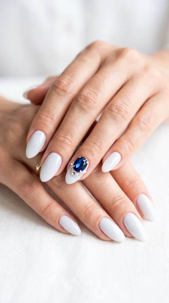 A woman with blue nail polish and a ring on her finger.
