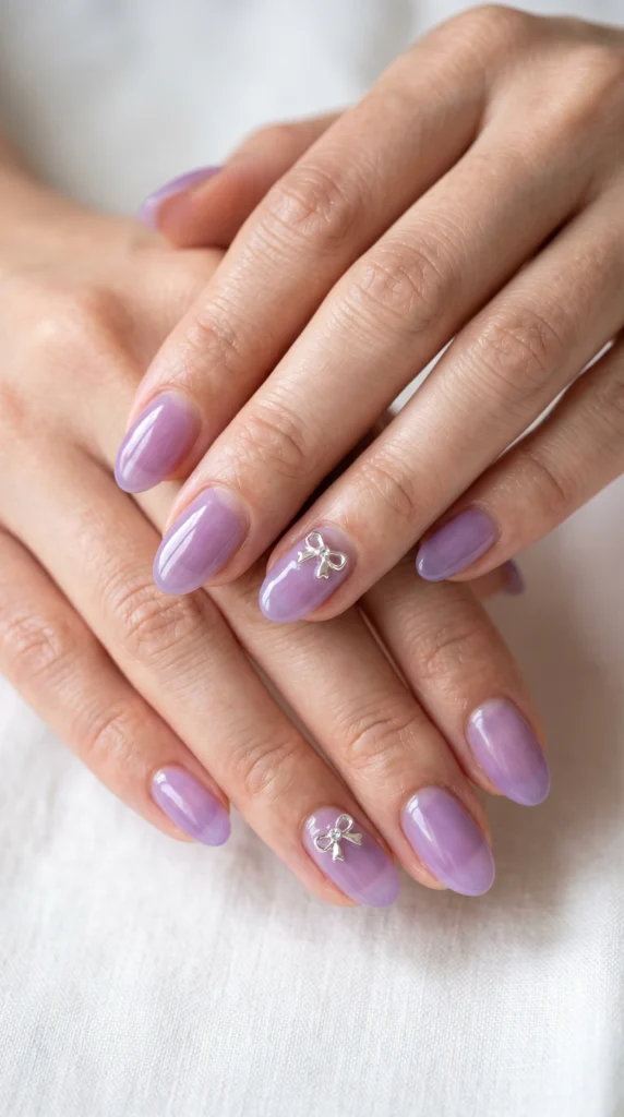Oval translucent lavender jelly nails with micro bow charms at cuticle — delicate soft girl design