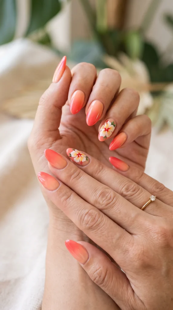 A woman with orange nail polish and a ring on her finger.