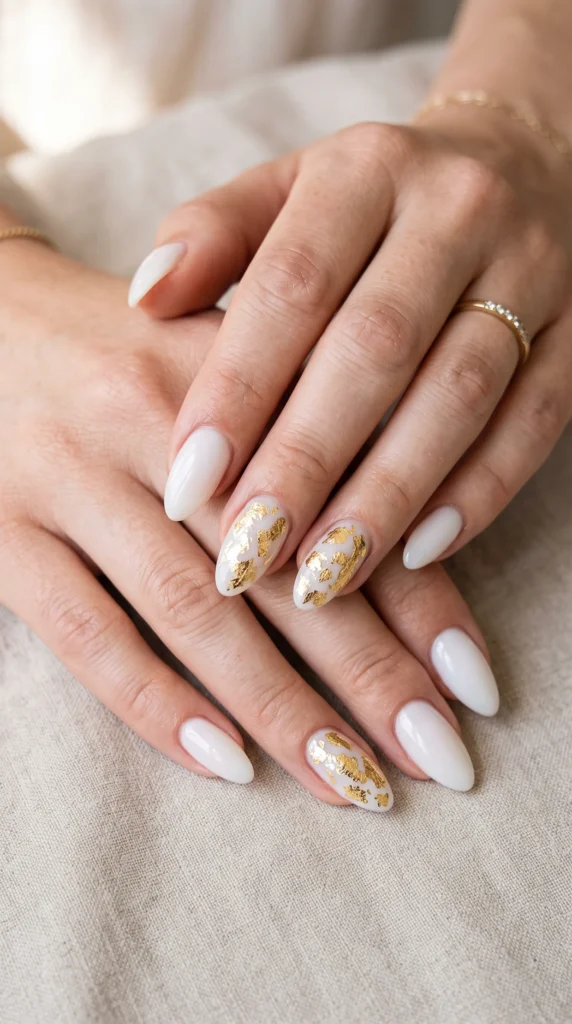 A woman with white nails and gold accents.