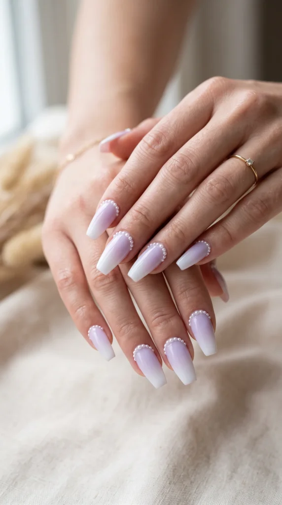 A woman's hand with purple nail polish and white tips.