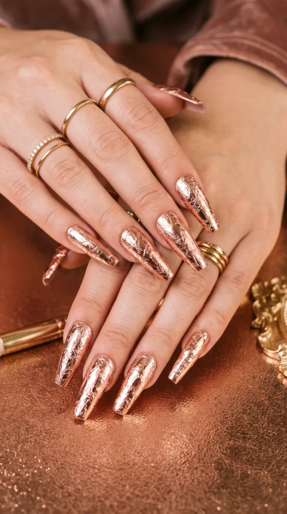 A woman with gold nail polish on her fingernails.