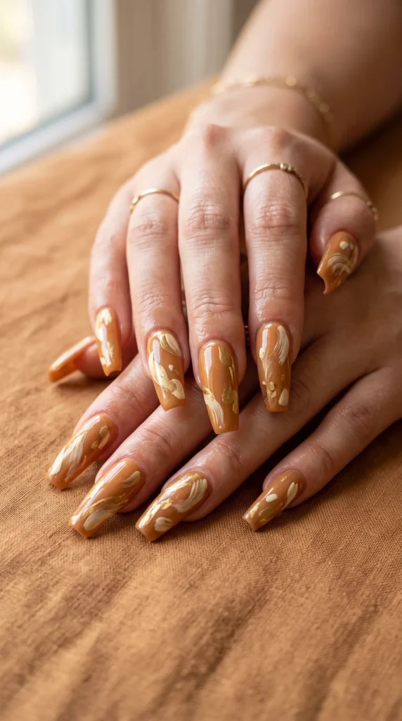 A woman with a gold nail polish on her fingernails.