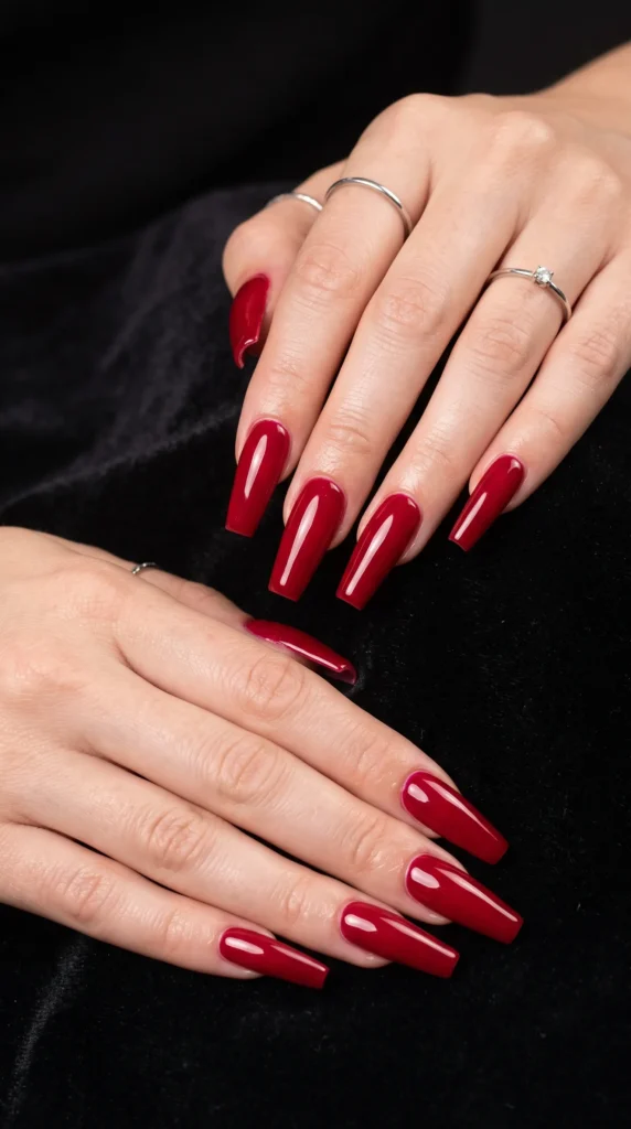 A woman with red nail polish on her fingers.