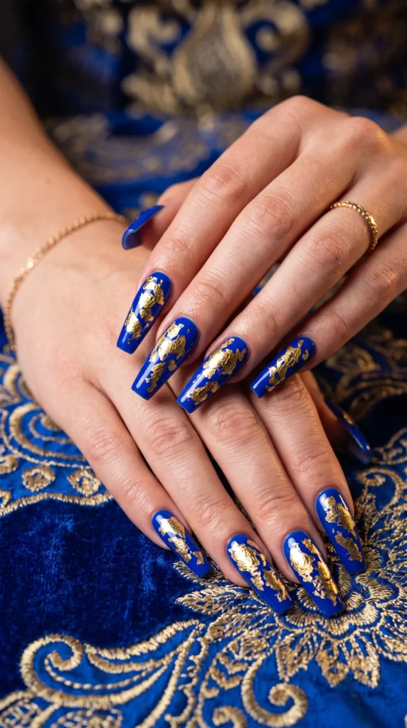 A woman with blue nails and gold designs.