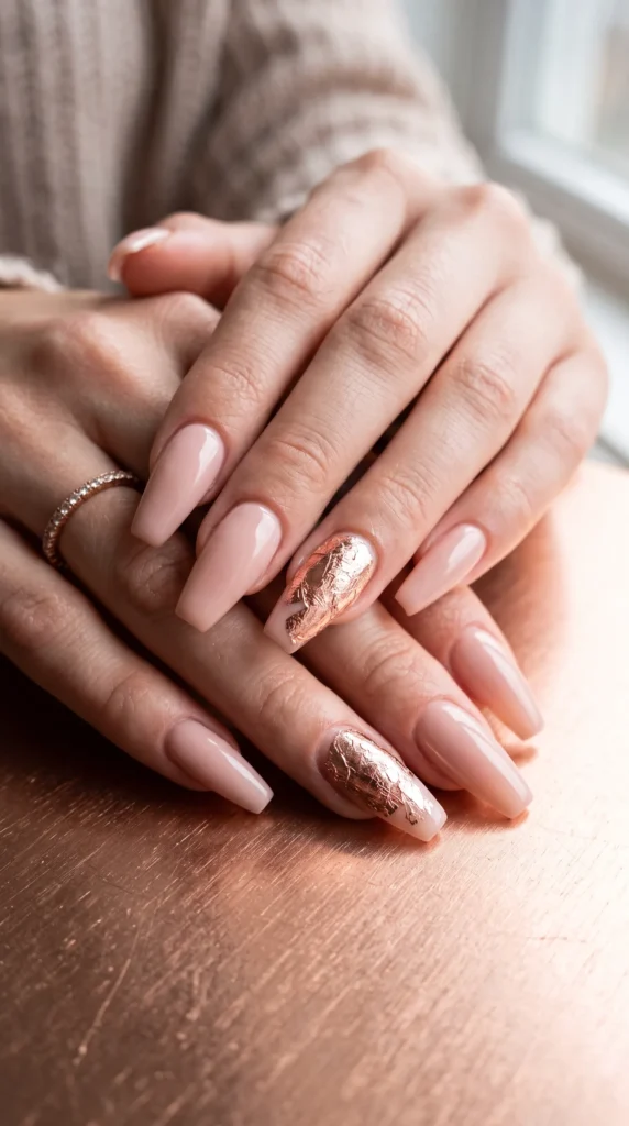 A woman with pink nails and a ring on her finger.