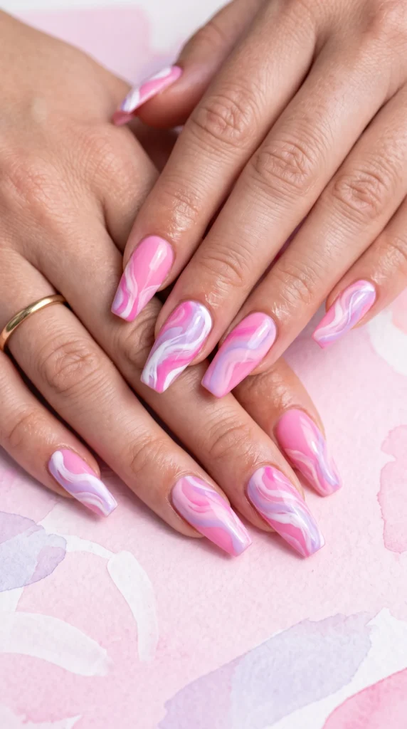 A hand with pink and white nail polish.