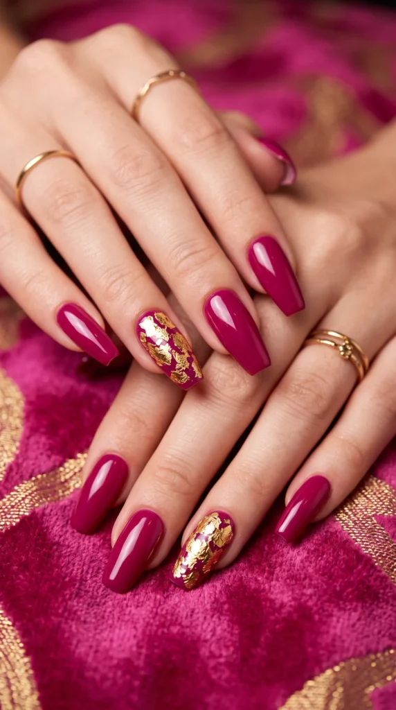 A woman with pink nail polish and gold accents on her nails.