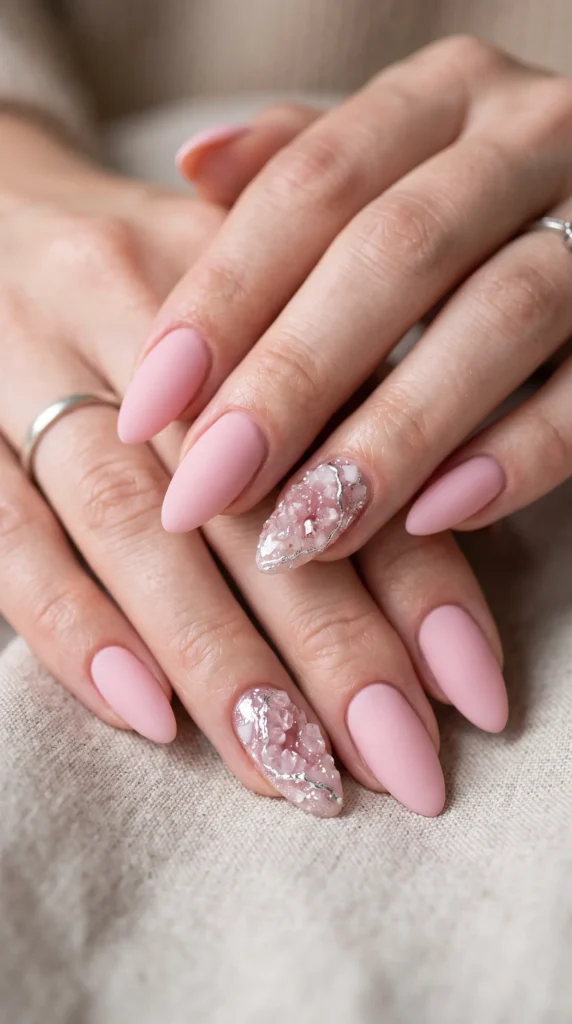 A woman with pink nail polish and a ring on her finger.