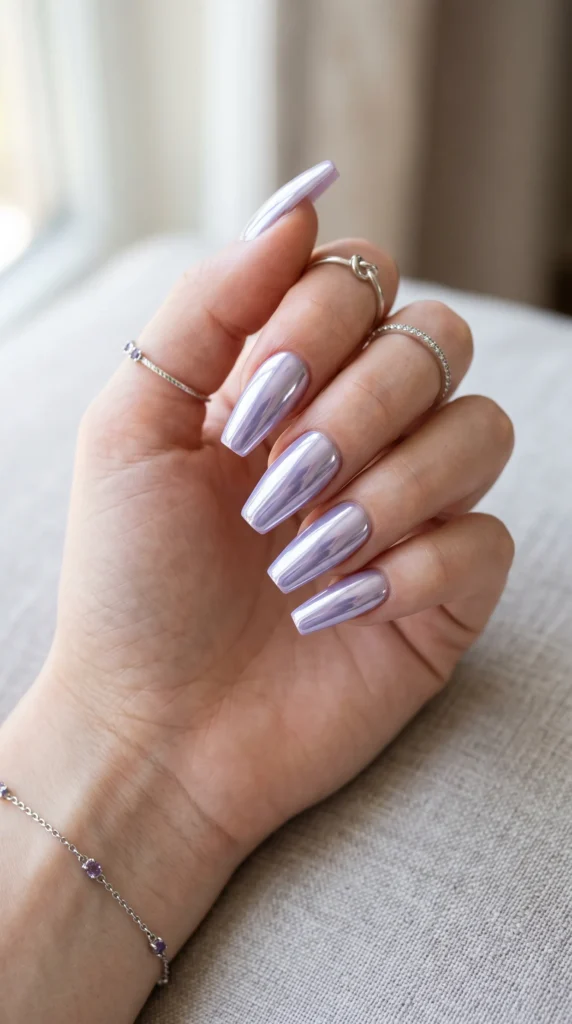 A woman's hand with a purple nail polish.