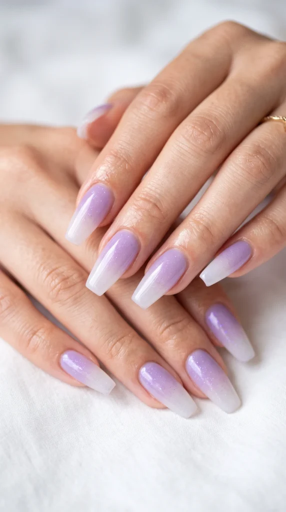 A person's hand with purple nail polish.