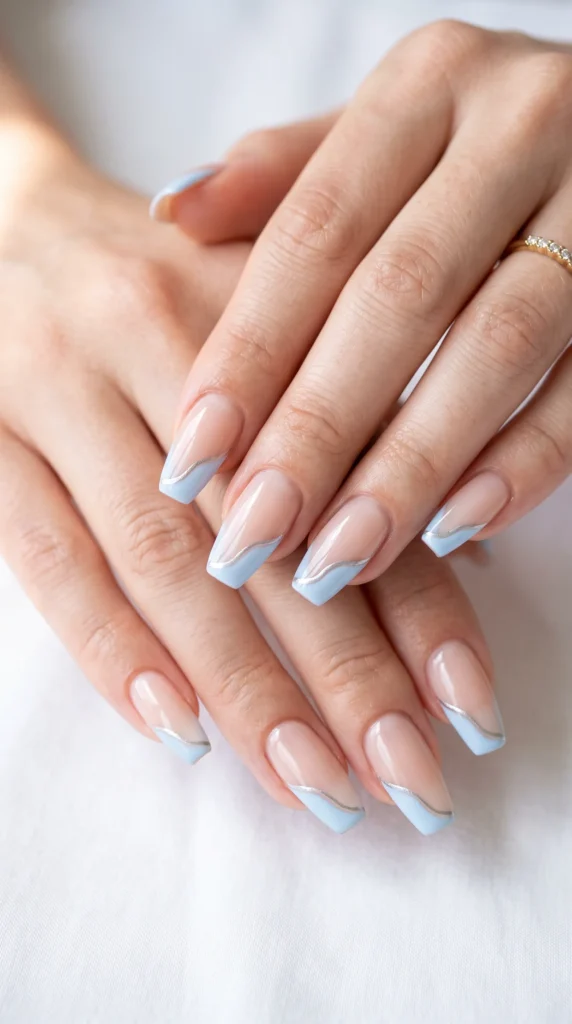 A person's hand with blue and white nail polish.