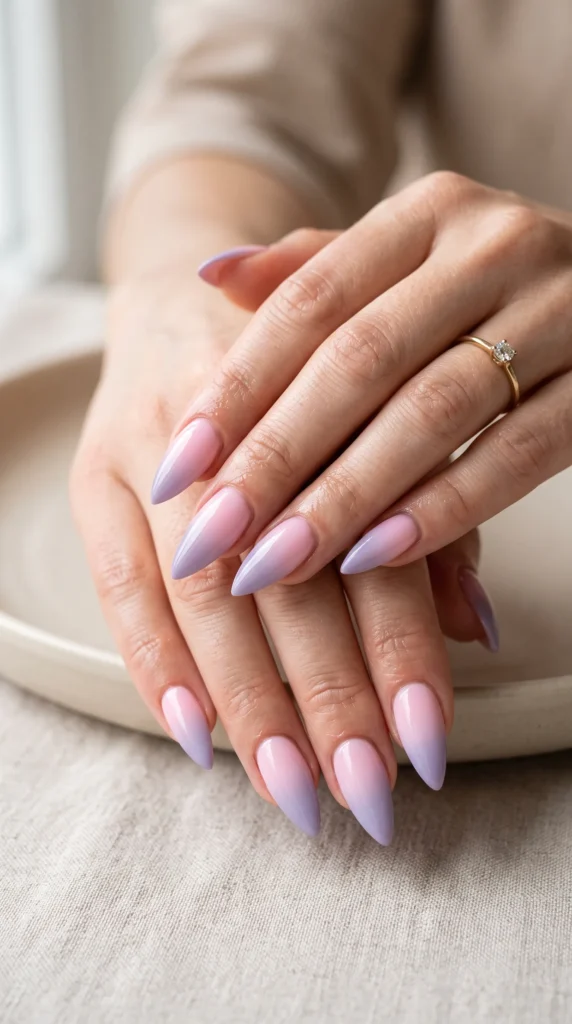 A woman with purple nails and a ring on her finger.