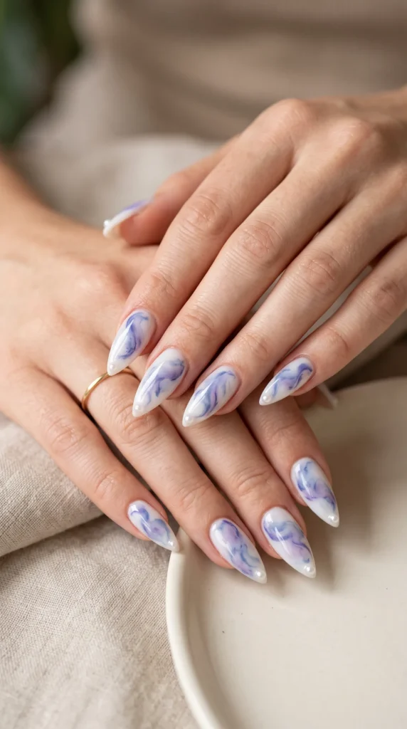 A person's hand with blue and white nail polish.,
summer soft girl nails