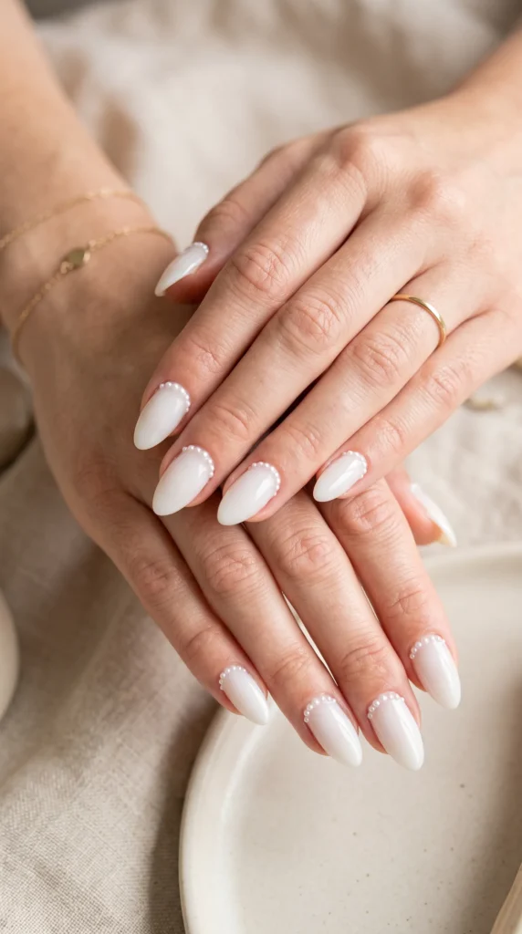 A woman with white nail polish on her fingers.