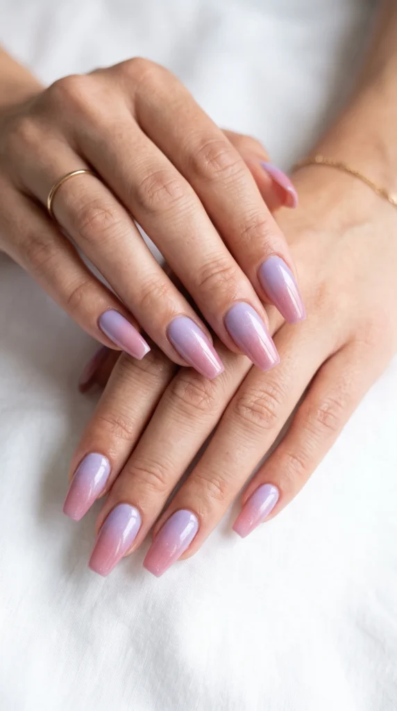 A woman's hands with purple nail polish.