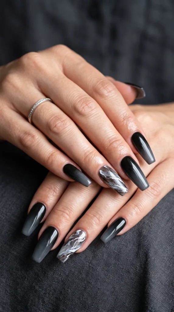 A woman with black nails and a silver ring on her finger.