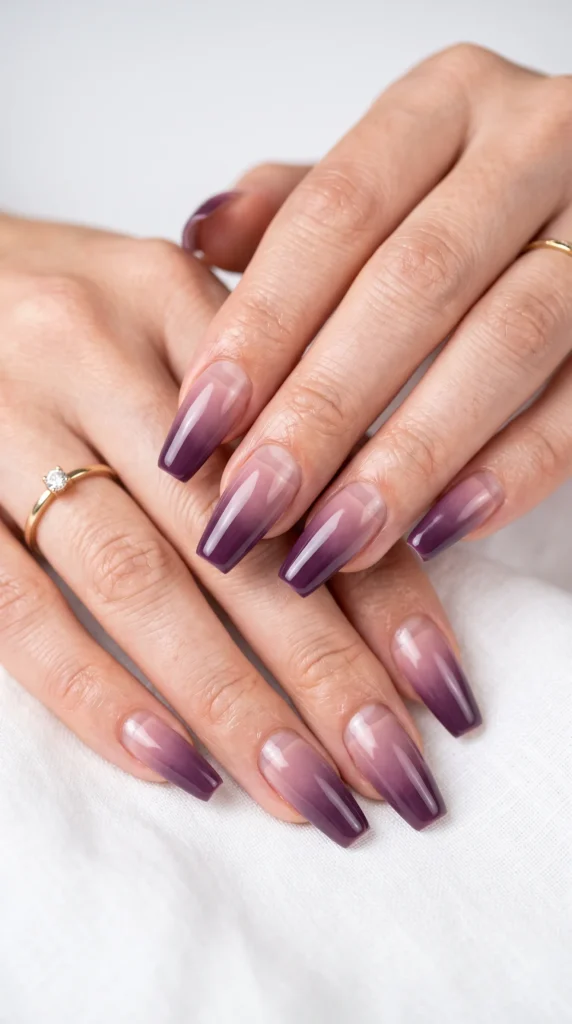 A person with purple nails and a ring on their finger.