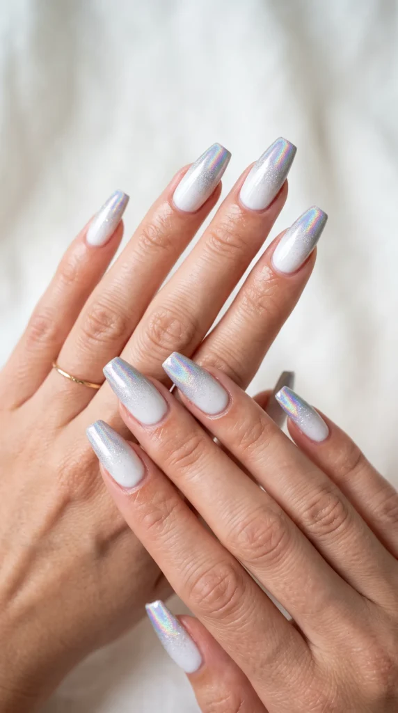 A person's hand with a ring on the middle finger and white nail polish.