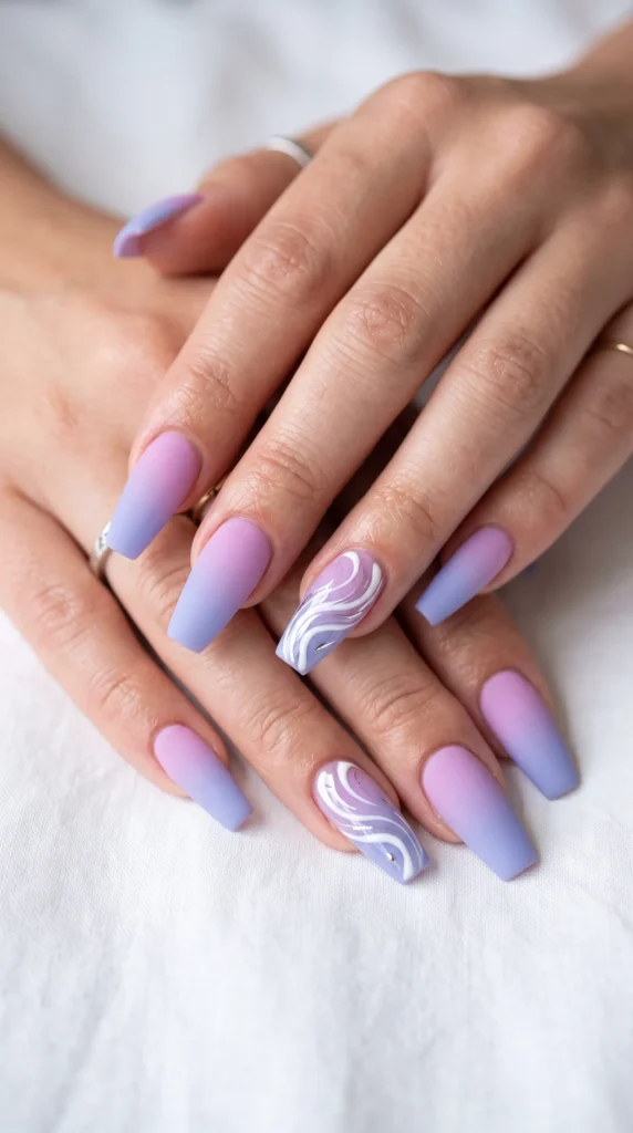 A person's hands with purple and white nail polish.