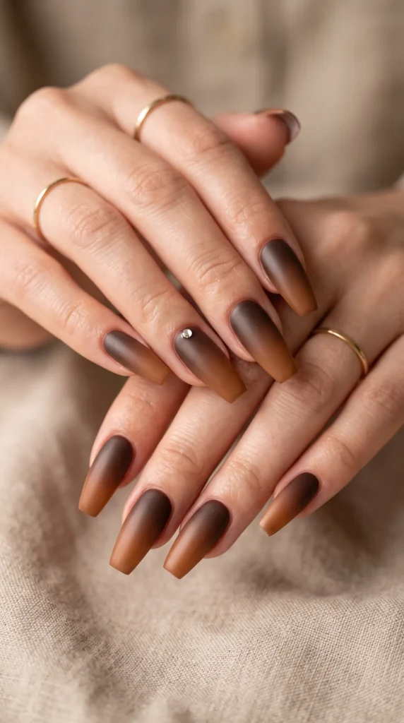 A woman with brown nail polish on her fingers.