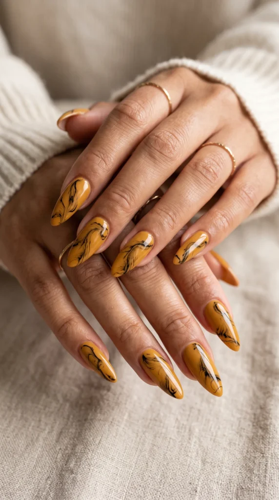 A person with yellow nail polish and a ring on their finger.