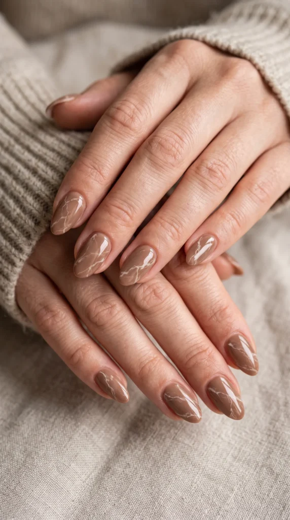 A woman with light brown nail polish on her fingers.