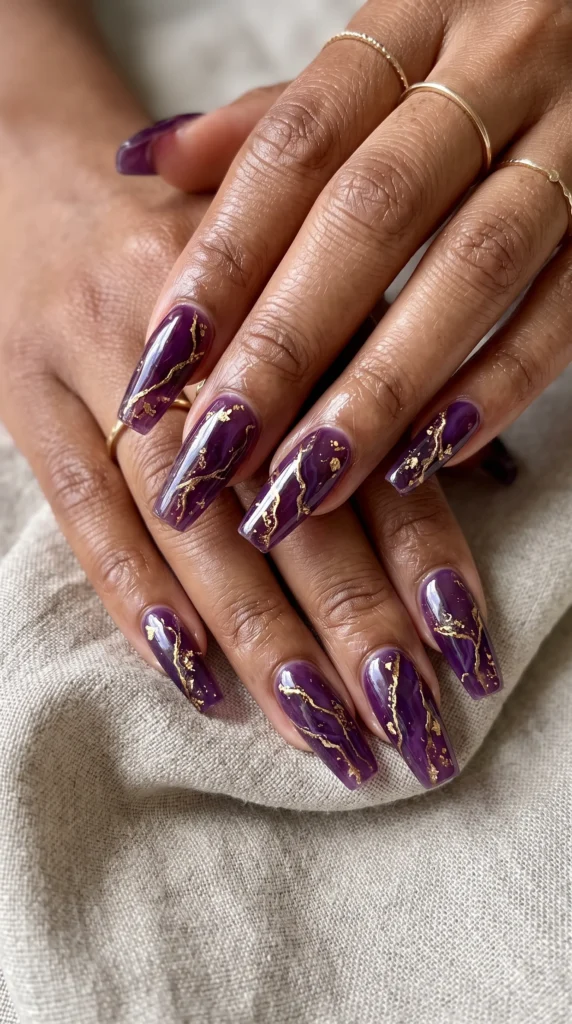 A woman with purple nails and gold accents.